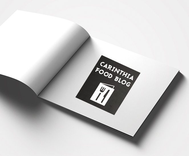 Ein Buch zeigt das Logo des Kunden Adi Kulterer Carinthia Food Blog, welches von der Werbeagentur Werbereich OG erstellt wurde.