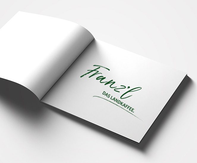 Ein Buch zeigt das Logo des Kunden Cafe Franzl, welches von der Werbeagentur Werbereich OG erstellt wurde.